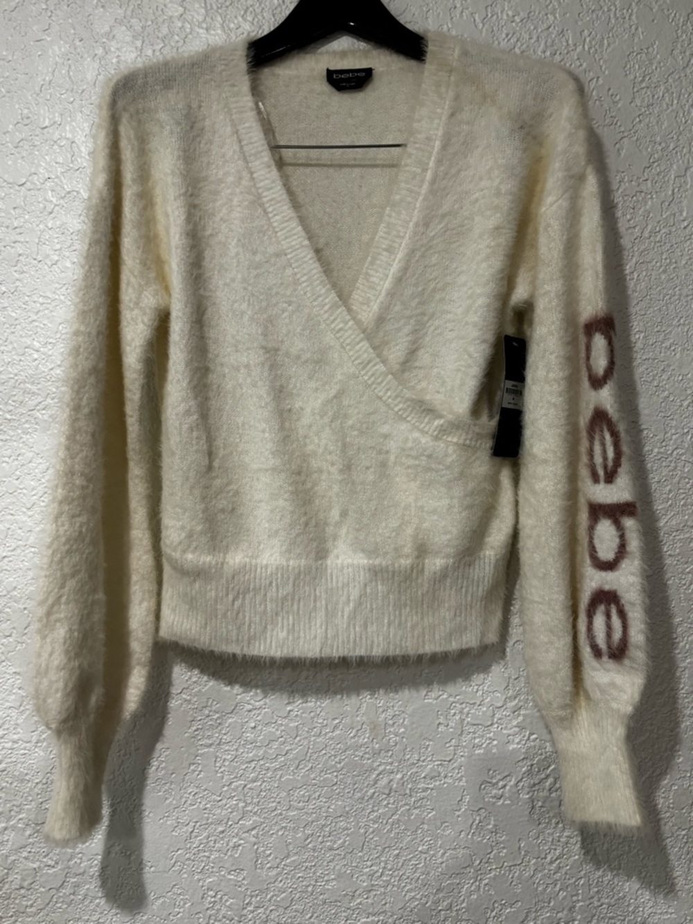 bebe Cream Fuzzy Wrap V-Neck Sweater with Logo Sleeve